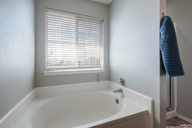 bathroom featuring shower with separate bathtub