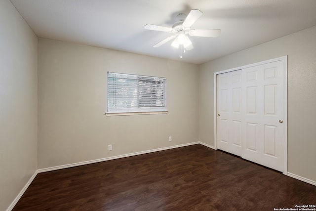 unfurnished bedroom featuring hardwood / wood-style floors, a closet, and ceiling fan