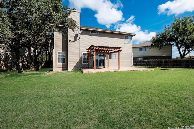 rear view of property with a pergola, a yard, and a patio area