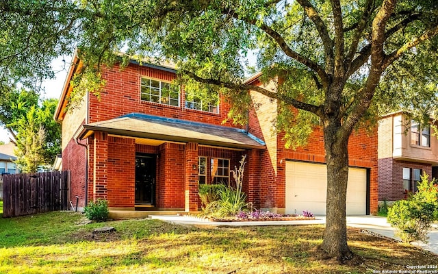 traditional home featuring a garage, brick siding, concrete driveway, fence, and a front yard