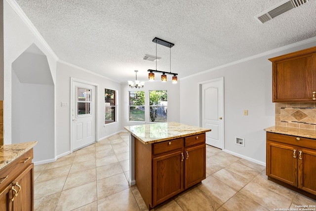 kitchen with brown cabinets, visible vents, and decorative backsplash