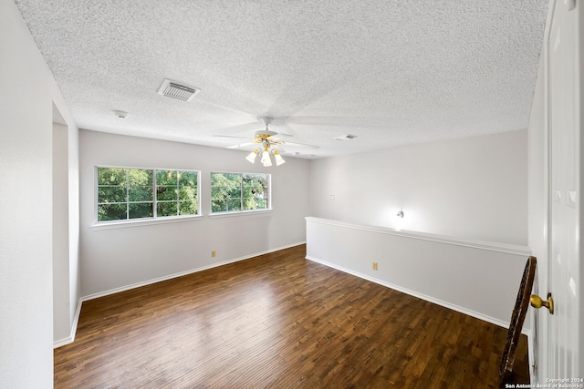 unfurnished room featuring visible vents, ceiling fan, baseboards, and wood finished floors