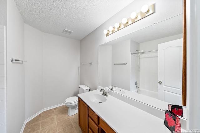 bathroom with a textured ceiling, toilet, visible vents, vanity, and baseboards