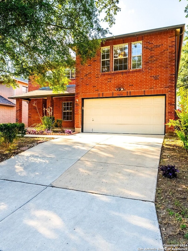 view of front facade with concrete driveway, brick siding, and an attached garage