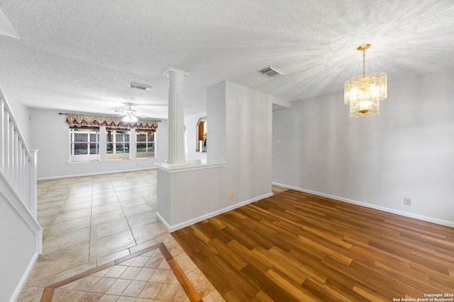 empty room with visible vents, decorative columns, and baseboards