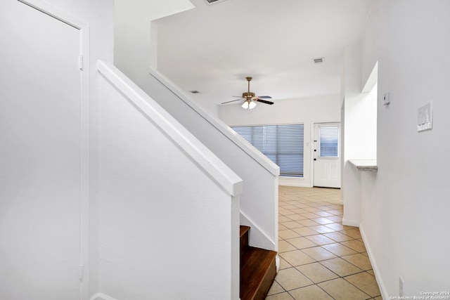 staircase with ceiling fan, baseboards, visible vents, and tile patterned floors