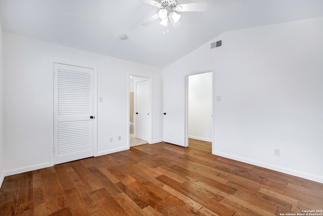 unfurnished bedroom featuring ceiling fan, hardwood / wood-style floors, and vaulted ceiling