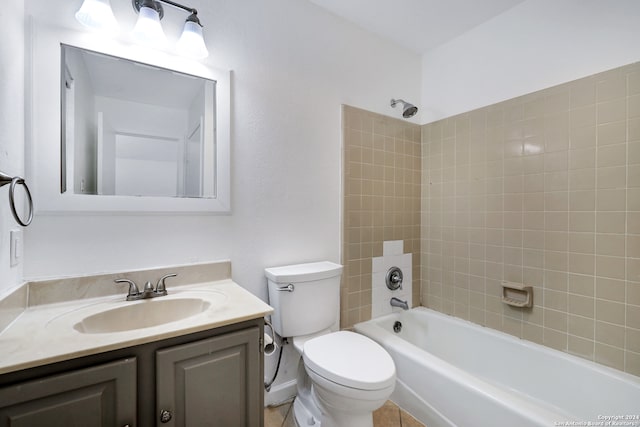 full bathroom with tile patterned floors, tiled shower / bath combo, vanity, and toilet