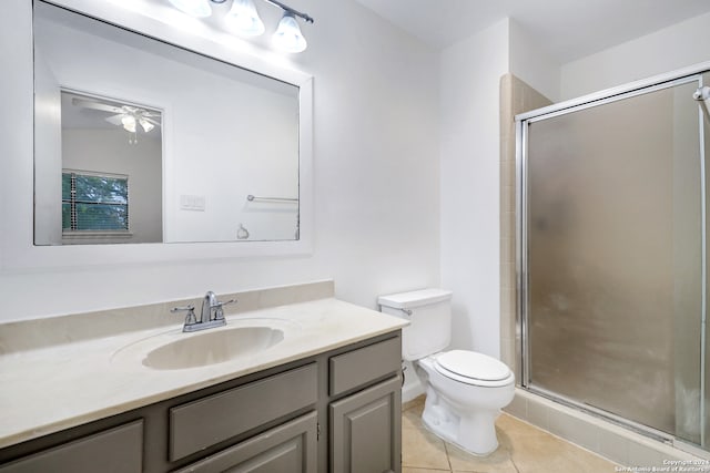 bathroom with ceiling fan, toilet, tile patterned floors, vanity, and a shower with shower door