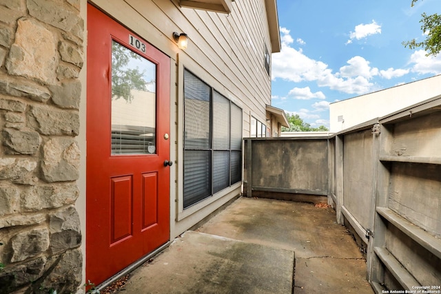 view of exterior entry featuring a patio