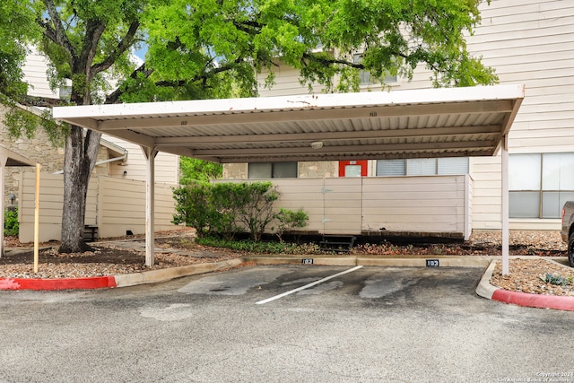 view of parking / parking lot featuring a carport