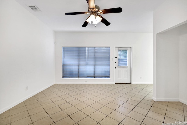 unfurnished room with a ceiling fan, visible vents, and baseboards