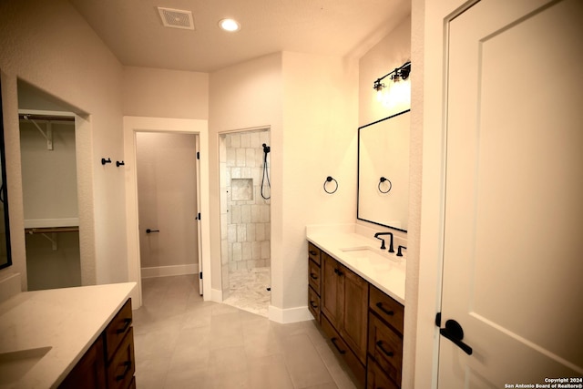 bathroom featuring vanity and tiled shower