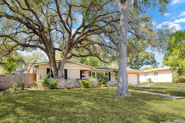 ranch-style house featuring a front yard and a garage