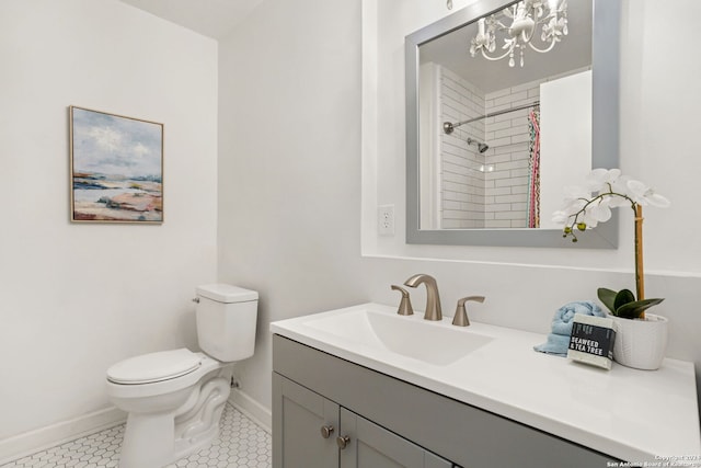 bathroom with a notable chandelier, toilet, tile patterned floors, and vanity