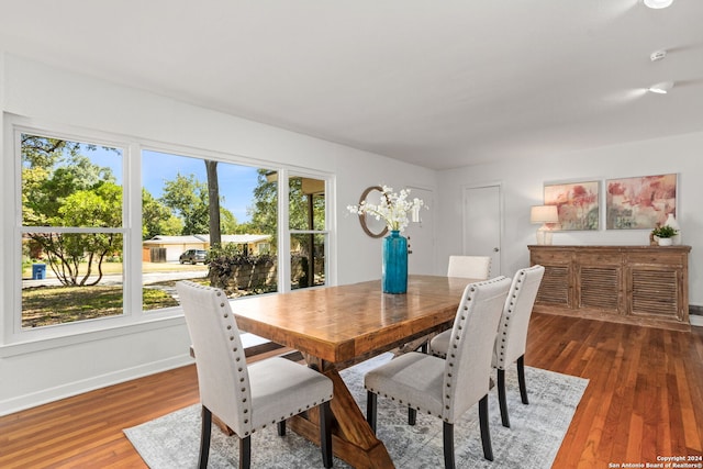 dining space with hardwood / wood-style flooring and a wealth of natural light