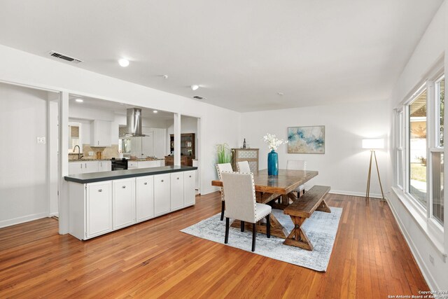 kitchen featuring tasteful backsplash, stainless steel appliances, white cabinets, and light stone countertops