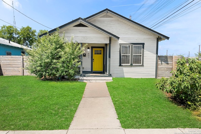 bungalow-style home with a front lawn