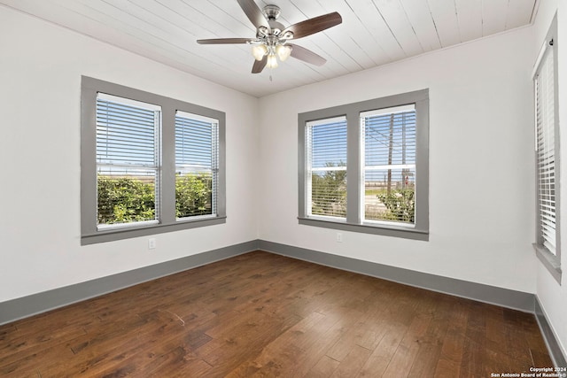 empty room featuring ceiling fan, wood-type flooring, and plenty of natural light