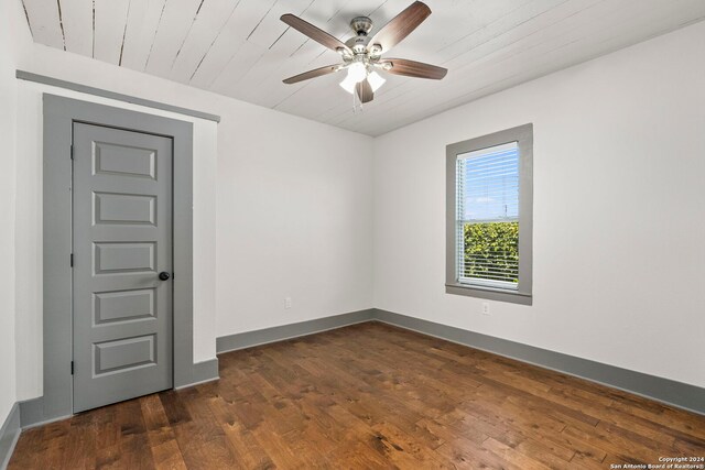 empty room with ceiling fan and wood-type flooring