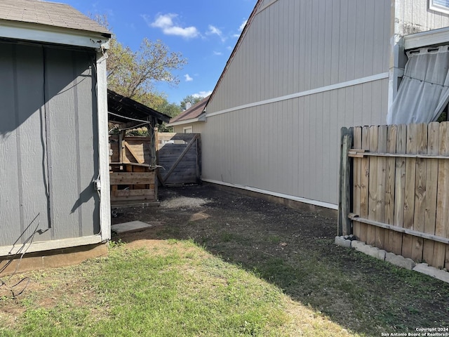 view of yard featuring an outdoor structure and fence