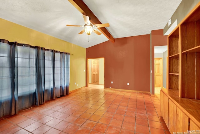 empty room with vaulted ceiling with beams, a textured ceiling, tile patterned floors, and ceiling fan