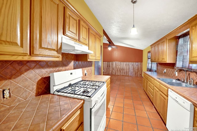 kitchen with tile counters, dishwasher, sink, decorative backsplash, and gas stove