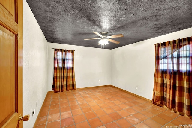 tiled empty room with ceiling fan and a healthy amount of sunlight