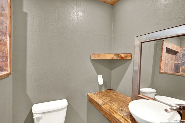 bathroom featuring sink and toilet