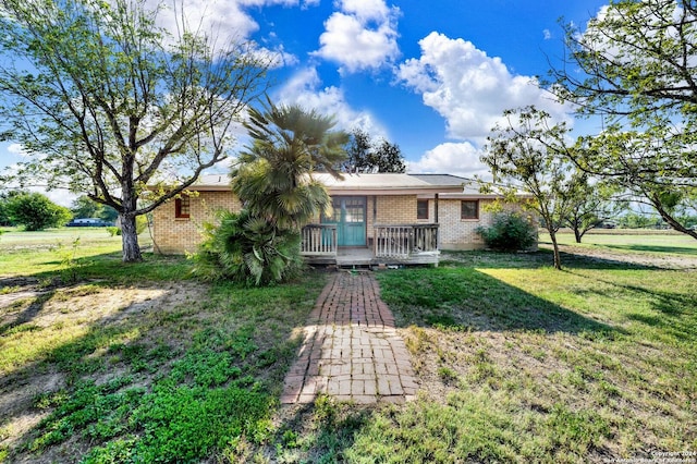 back of house featuring a yard and a wooden deck