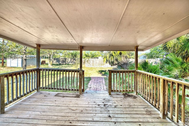 deck with a lawn and a shed