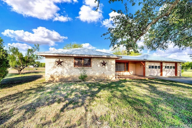 ranch-style home with a garage and a front lawn