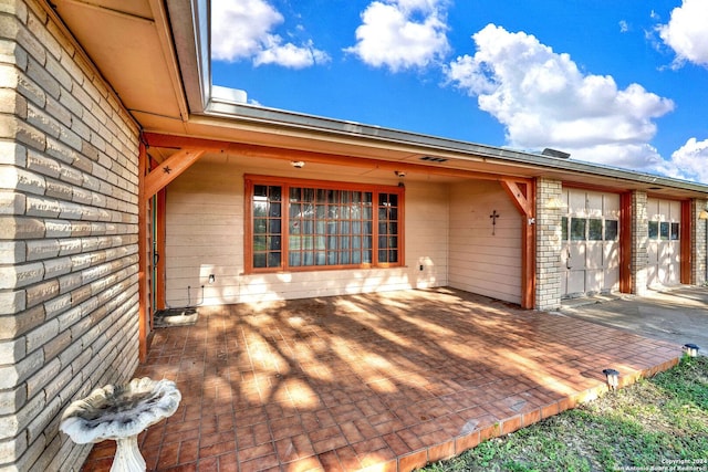 property entrance featuring a patio area