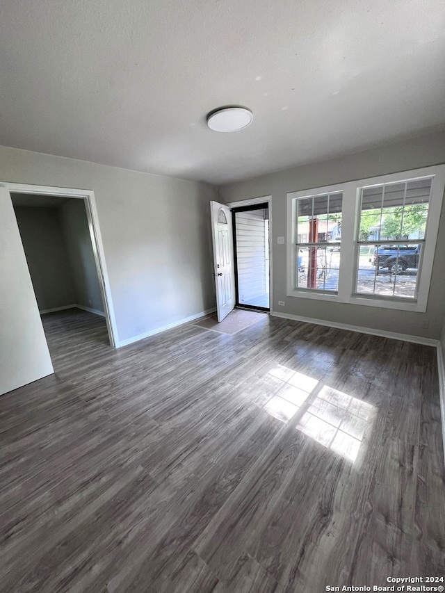 empty room with hardwood / wood-style flooring