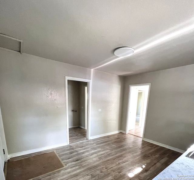 unfurnished bedroom featuring hardwood / wood-style flooring and a closet