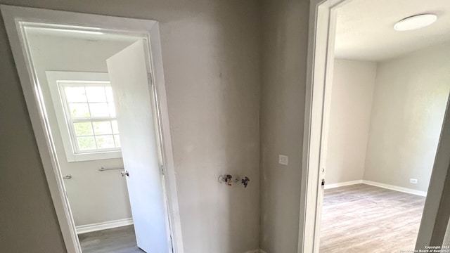 corridor with hardwood / wood-style flooring