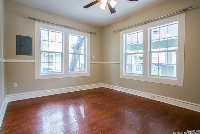 empty room featuring plenty of natural light and hardwood / wood-style floors