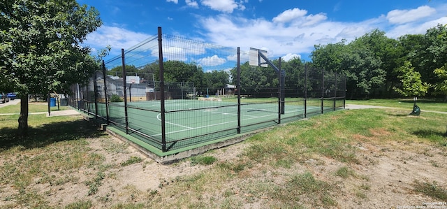 exterior space featuring tennis court and a lawn