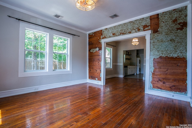 spare room featuring crown molding and hardwood / wood-style flooring