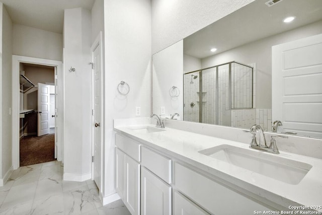 bathroom featuring vanity and a shower with shower door