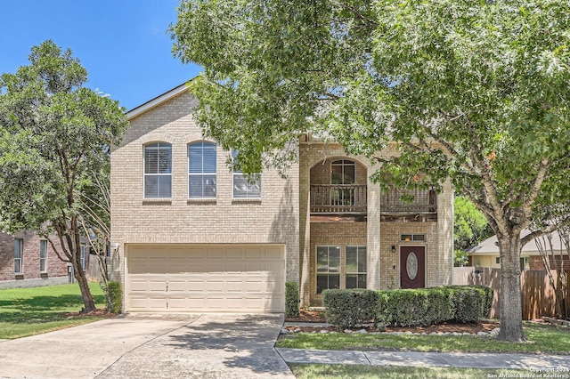 view of front of home featuring brick siding, an attached garage, fence, a balcony, and driveway