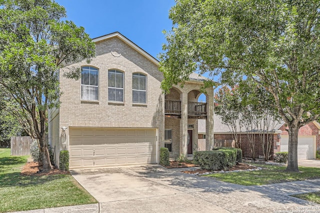 view of front of property with driveway, a balcony, an attached garage, fence, and brick siding