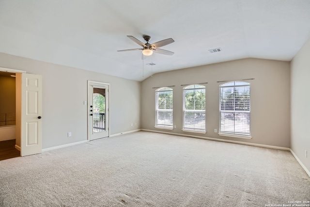 carpeted empty room featuring ceiling fan and vaulted ceiling