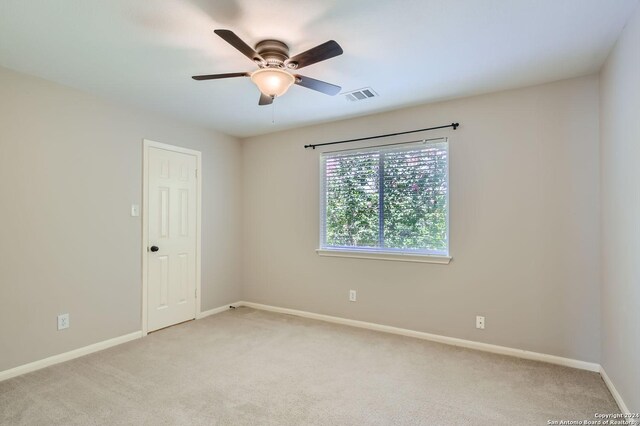 carpeted empty room with ceiling fan