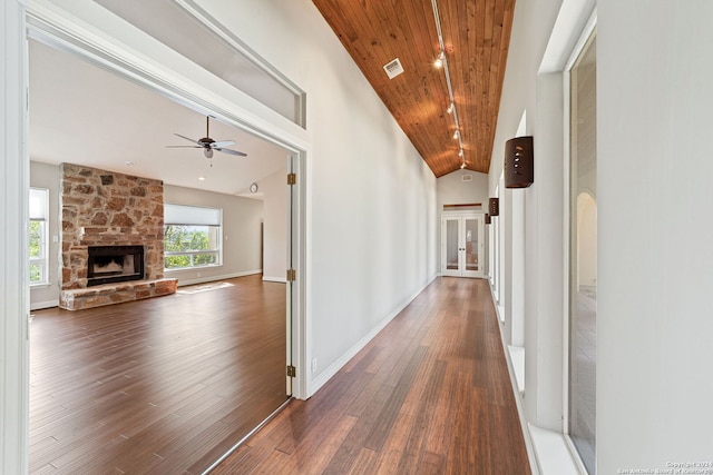 hallway with dark wood-type flooring, high vaulted ceiling, and wooden ceiling