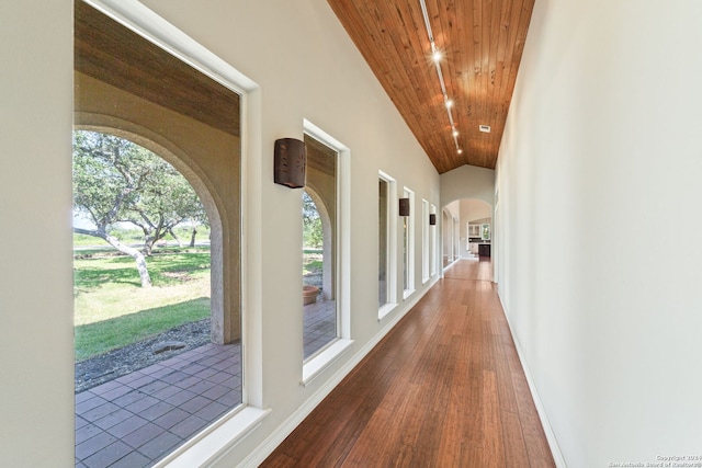 hallway featuring hardwood / wood-style floors, a wealth of natural light, and wooden ceiling