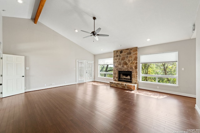 unfurnished living room featuring beam ceiling, high vaulted ceiling, a fireplace, and hardwood / wood-style floors