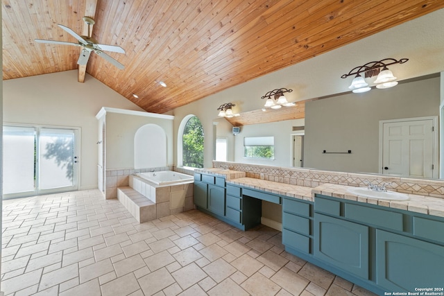 bathroom with wooden ceiling, tile patterned floors, double vanity, a relaxing tiled tub, and ceiling fan