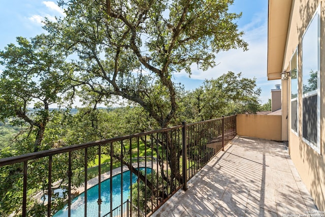 balcony featuring a fenced in pool