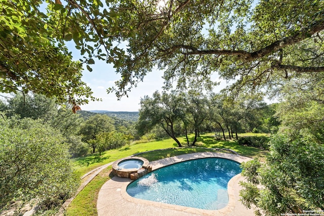 view of swimming pool featuring an in ground hot tub